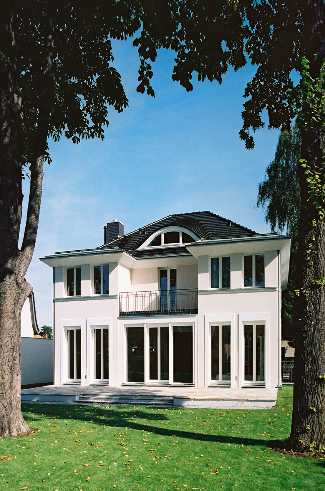 Zum Garten öffnet sich die Villa mit Terrasse und Balkon.