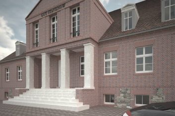 Das neue Portal aus Travertin kontrastiert zum Altbau aus Backstein.